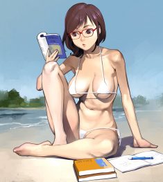 Girl in bikini reads a book outdoors